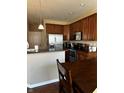 Well-equipped kitchen featuring stainless steel appliances and dark wooden cabinetry at 14309 Shooting Star Dr, Noblesville, IN 46060
