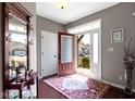 Welcoming foyer with a decorative mirror, a red accent rug, and lots of natural light at 17136 Wetherington Dr, Westfield, IN 46074