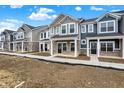 Newly built townhomes with varying colors and brick under a blue sky at 19499 Grassy Branch Rd, Westfield, IN 46074