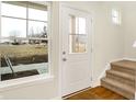 Bright foyer showcasing a front door, stairway, and large window at 19499 Grassy Branch Rd, Westfield, IN 46074
