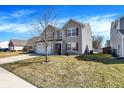 Side view of a two-story home featuring vinyl siding, maroon shutters, and green grass at 3079 Limber Pine Dr, Whiteland, IN 46184
