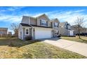 A well-maintained two-story home with a two-car garage, vinyl siding, and a manicured lawn at 3079 Limber Pine Dr, Whiteland, IN 46184