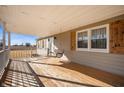 Relaxing porch with a wooden swing, windows with shutters and views of the front yard at 3226 E 300 N, Anderson, IN 46012