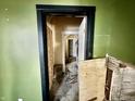 Interior view of a home featuring an entrance to other rooms, showcasing exposed framework and renovation potential at 327 N Bradley Ave, Indianapolis, IN 46201