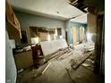 An interior showcases demolition with debris and exposed framework, offering renovation potential and a spacious layout at 327 N Bradley Ave, Indianapolis, IN 46201