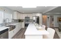 Bright kitchen featuring white cabinets, stainless steel appliances, and stone backsplash at 3406 E 20Th St, Indianapolis, IN 46218