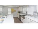 Bright kitchen featuring white cabinets, stainless steel appliances, and stone backsplash at 3406 E 20Th St, Indianapolis, IN 46218