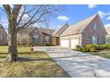 Charming brick home featuring a spacious driveway and beautiful front lawn at 3520 Inverness Blvd, Carmel, IN 46032
