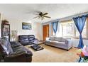 Comfortable living room with neutral carpet, ceiling fan, and ample natural light at 358 Webb Dr, Indianapolis, IN 46227