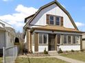 Attractive two-story house showcases detailed trim, large windows, and a neatly kept yard at 360 S Spencer Ave, Indianapolis, IN 46219