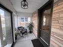 Cozy enclosed porch with brick accent wall, rocking chair, and ample natural light at 360 S Spencer Ave, Indianapolis, IN 46219