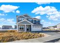 Charming two-story home with stone accents and a two-car garage, set against a blue sky with clouds at 3667 Thomas Jefferson St, Westfield, IN 46074