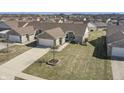 An elevated shot of a home with a driveway, front yard and neighborhood overview at 3677 Cedar Cove Ct, New Palestine, IN 46163