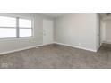 Bright, carpeted bedroom featuring a window, neutral walls, and a modern interior door at 3732 Wellington Ave, Indianapolis, IN 46226