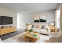 Bright living room with stylish decor, plush seating, and large windows filling the space with natural light at 3732 Wellington Ave, Indianapolis, IN 46226