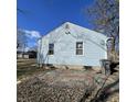 View of the rear of the home with light blue siding, showing the backyard at 3748 N Olney St, Indianapolis, IN 46218