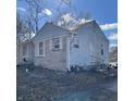 Exterior view of the side of the house, showing mixed siding textures and yard at 3748 N Olney St, Indianapolis, IN 46218