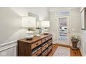 Well-lit foyer with hardwood floors, stylish console table, and elegant decor at 4215 Heyward Pl, Indianapolis, IN 46250