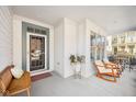 Inviting covered front porch with seating area, perfect for relaxing outdoors at 4215 Heyward Pl, Indianapolis, IN 46250