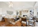Open-concept living and dining area with hardwood floors and fireplace at 4215 Heyward Pl, Indianapolis, IN 46250