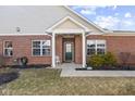 Inviting entryway features a brick facade, decorative front door, and a well-maintained garden adding charm at 5115 Baltustrol Dr, Avon, IN 46123