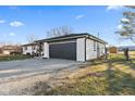 Wide view of a ranch style home showing a 2-car garage and a pea gravel driveway at 5195 N Frontage Rd, Fairland, IN 46126