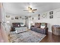 Cozy living room featuring two comfortable reclining sofas, a ceiling fan, and decor at 5195 N Frontage Rd, Fairland, IN 46126