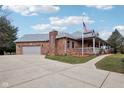 This attractive home boasts a convenient two-car garage, a sprawling driveway, and a lovely, covered porch at 520 Denny Dr, Mooresville, IN 46158