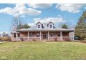 Charming brick home featuring a spacious front porch and lush lawn, perfect for relaxing or entertaining outdoors at 520 Denny Dr, Mooresville, IN 46158