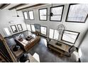Bright, open-concept living room with high ceilings, large windows, stylish furniture, and a dining area at 7143 W 50 S, Morgantown, IN 46160