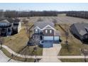 Expansive aerial view of the two-story home showing the large yard and neighborhood at 7675 Winding Lake S Dr, Noblesville, IN 46062