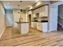Modern kitchen with white cabinets, black countertops, stainless steel faucet, and hardwood floors at 924 N Oakland Ave, Indianapolis, IN 46201