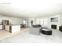 Open concept living and kitchen area with stainless steel appliances, fireplace, and a cozy gray sofa at 936 Plunkett Ave, Westfield, IN 46074