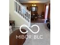 Open-concept view of dining area and a staircase leading to additional rooms at 9808 Worthington Blvd, Fishers, IN 46038
