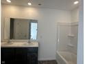 Bathroom with a double sink vanity, large mirror, and a combined bathtub and shower at 10265 Cliff Ln, Indianapolis, IN 46239