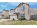 Charming two-story home with a well-maintained lawn, brick facade, attached garage, and neutral color scheme at 10294 Lothbury Cir, Fishers, IN 46037
