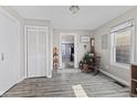 View of a dining area with wood-look floors, a rocking chair, and an open doorway to another room at 1205 S Dequincy St, Indianapolis, IN 46203