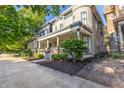 Street view of a gracious home with a charming front porch and beautifully landscaped yard at 1471 N Delaware St, Indianapolis, IN 46202
