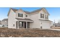 Beautiful two-story home with light siding, black shutters, and a convenient attached two-car garage at 1585 N Regatta Dr, Greenfield, IN 46140