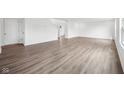 Spacious living room featuring beautiful wood-look flooring and ample natural light at 1585 N Regatta Dr, Greenfield, IN 46140