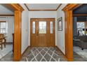 Inviting foyer with wood trim, decorative glass door, and stylish rug, creating a warm entrance to the home at 1622 E Mohr Rd, Greenfield, IN 46140