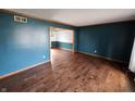 Spacious living room with hardwood floors, wood trim, and fresh, neutral paint at 16575 Audubon Ct, Noblesville, IN 46060