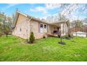 The brick home has a covered front porch and landscaping at 1794 Bell Rd, Morgantown, IN 46160