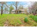 Charming brick home with a covered porch and a yard with mature trees and landscaping at 1794 Bell Rd, Morgantown, IN 46160