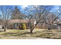 Well-maintained one-story home with a stone facade and established landscaping in the front yard at 21 E Tilden Dr, Brownsburg, IN 46112