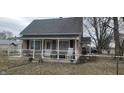 Exterior shot showcasing the front porch, weathered exterior, and front yard of the property at 2212 S Delawanda Ave, Muncie, IN 47302