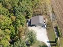 Aerial view of a large outbuilding surrounded by lush greenery and adjacent to open farmland at 2387 Bill Smith Rd, Martinsville, IN 46151