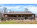 Charming single-story home with a welcoming front porch and decorative wagon wheels at 2389 Bill Smith Rd, Martinsville, IN 46151