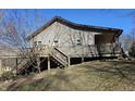 View of deck with stairs that lead to a hillside yard on a sunny day at 2389 Bill Smith Rd, Martinsville, IN 46151