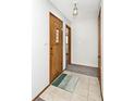 Inviting entryway featuring neutral tile flooring, a decorative front door, and convenient coat closet at 244 Corottoman Ct, Avon, IN 46123
